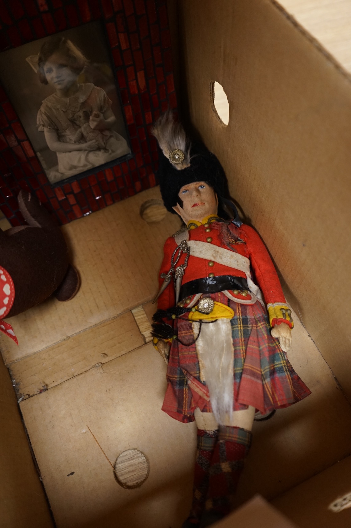 An English teddy bear and related photograph, a felt Scottish guardsman and soft toy rabbit